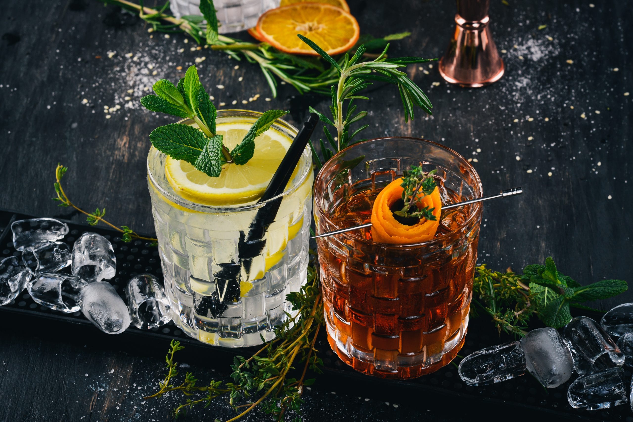 Alcohol free: Two cocktails in short glasses with an array of herbs surrounding the glasses